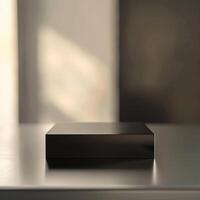 A black box sitting on a table in front of a window photo