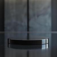 A black round table on a table with a black background photo