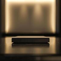 A black box sitting on a table in front of a wall photo