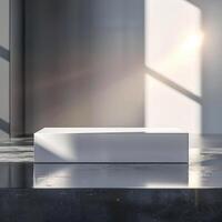 A white box sitting on a table in front of a window photo