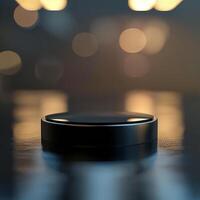 A black object sitting on a table in front of a blurry background photo
