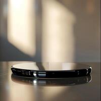 A black and silver circular object sitting on a table photo