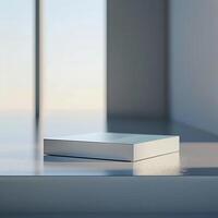 A white box sitting on a table in front of a window photo