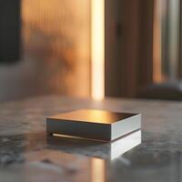 A square object sitting on a table in front of a window photo