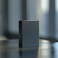 A black box sitting on a table in front of a window photo