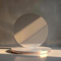 A round mirror on a stand in front of a wall photo