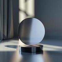 A round mirror on a table in front of a window photo