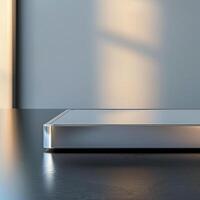 A silver box sitting on a table in front of a window photo