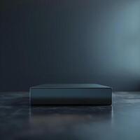 A black box sitting on a table in front of a dark wall photo