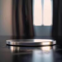 A silver plate on a table in front of a window photo
