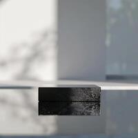A black box sitting on a table in front of a window photo