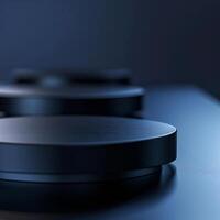 Three black circular objects on a table photo