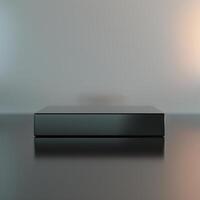 Black box on a table with a light behind it photo