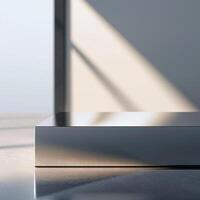 A modern metal table in front of a window photo