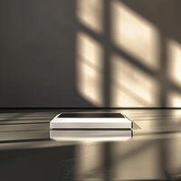 A white box sitting on a table in front of a window photo