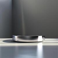A silver object on a table in front of a wall photo