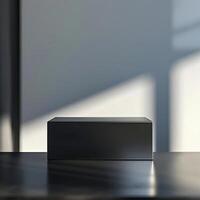 A black box sitting on a table in front of a window photo