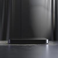 Black tv on a table in front of a black curtain photo