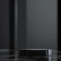 A black object sitting on a table in front of a black background photo