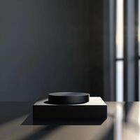 A black object on a table in front of a window photo