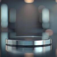 A silver circular object on a table in front of a blurry background photo