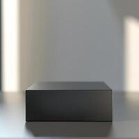 A black box sitting on a table in front of a wall photo