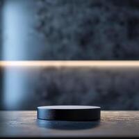 A black object sitting on a table in front of a wall photo