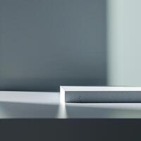 A white box sitting on a table in front of a wall photo