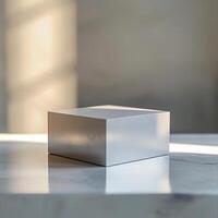A white cube sitting on a table in front of a window photo