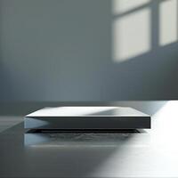 A white box sitting on a table in front of a window photo