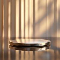 A silver plate on a table with a light behind it photo