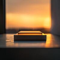 A small box sitting on a table in front of a sunset photo