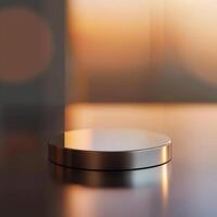 A silver object sitting on a table in front of a blurry background photo