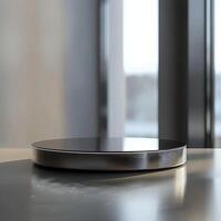 A black and silver circular object on a table photo