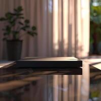 A black box sitting on a table in front of a window photo