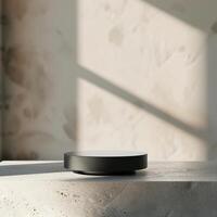 A black object sitting on a table in front of a wall photo