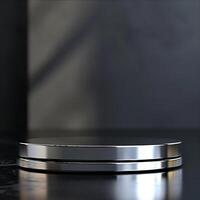 A silver circular object on a black surface photo