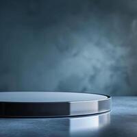 A round table with a silver top on a dark background photo