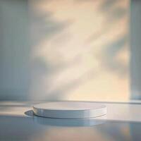 Empty white round pedestal on a table in front of a window photo