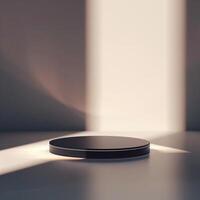 A black object on a table in front of a wall photo