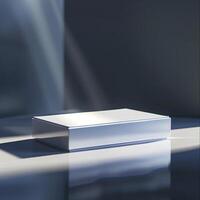 A white box sitting on a table in front of a window photo