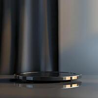 A black plate on a table with a curtain in the background photo