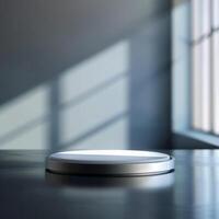 A white circular object sitting on a table in front of a window photo