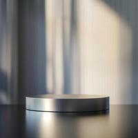 A silver round table on a table in front of a window photo
