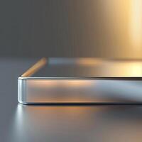 The back of a silver phone with a light shining on it photo