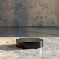 A black object sitting on a table in front of a wall photo