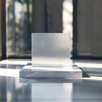 A white square on a table in front of a window photo