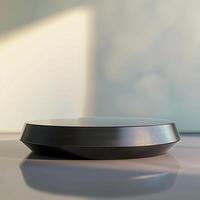 A black object on a table with a window in the background photo