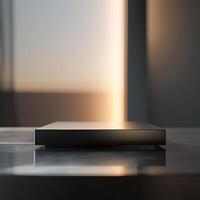 A black box sitting on a table in front of a window photo
