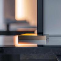 A square object sitting on a table in front of a window photo